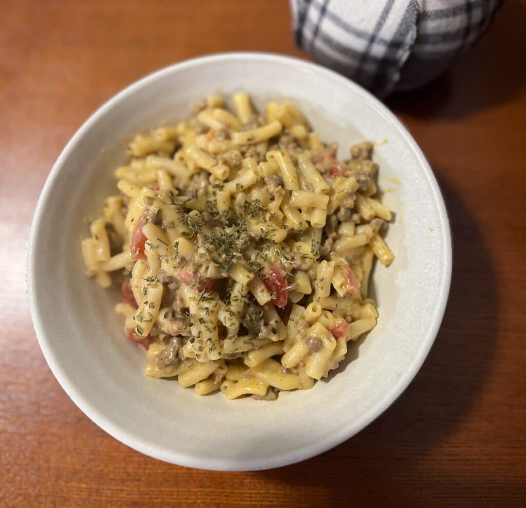 spicy macaroni and cheese in a bowl on a brown table