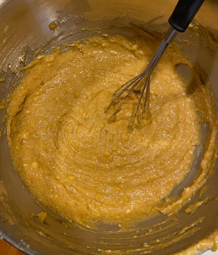 pumpkin bars batter in a mising bowl with a whisk