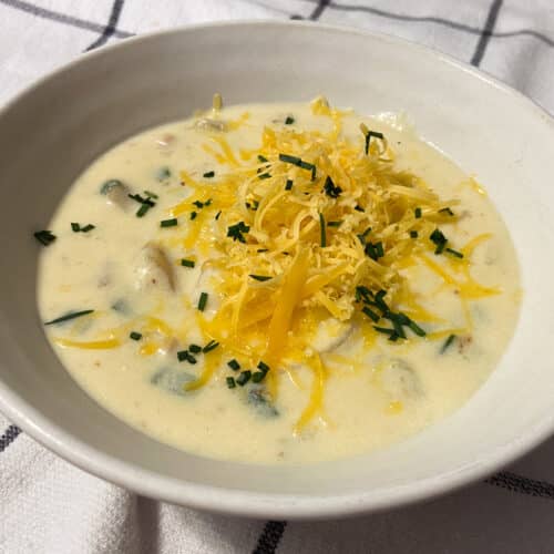 creamy baked potato soup with shredded cheddar cheese and chives