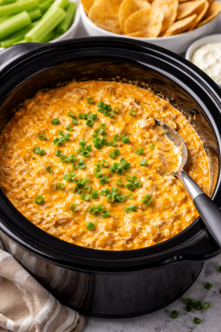 buffalo chicken dip in a crockpot with a serving spoon