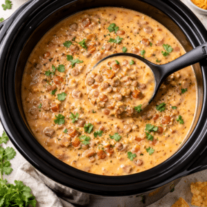 creamy taco soup in a crockpot with a serving spoon