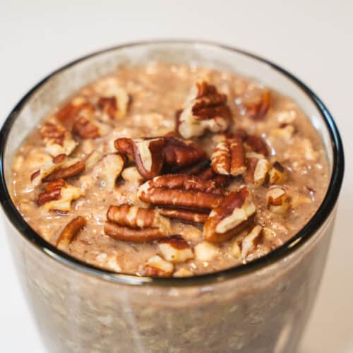 banana bread overnight oats in a glass with pecans on top