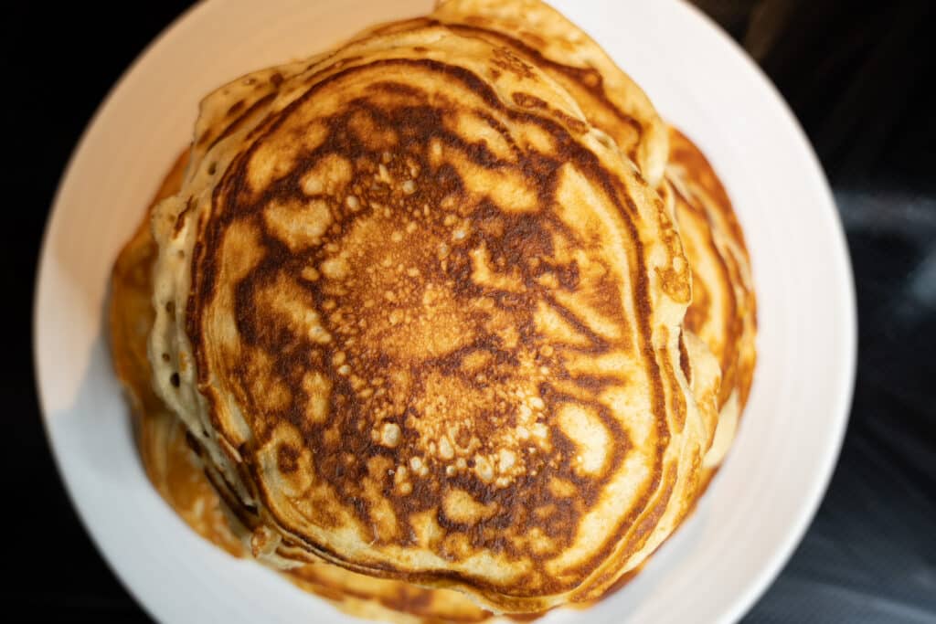 a view of sourdough discard pancakes from above with crispy golden edges