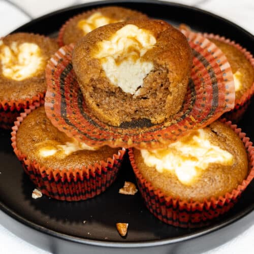 Pumpkin Cream Cheese Swirl Muffins sitting on a plate