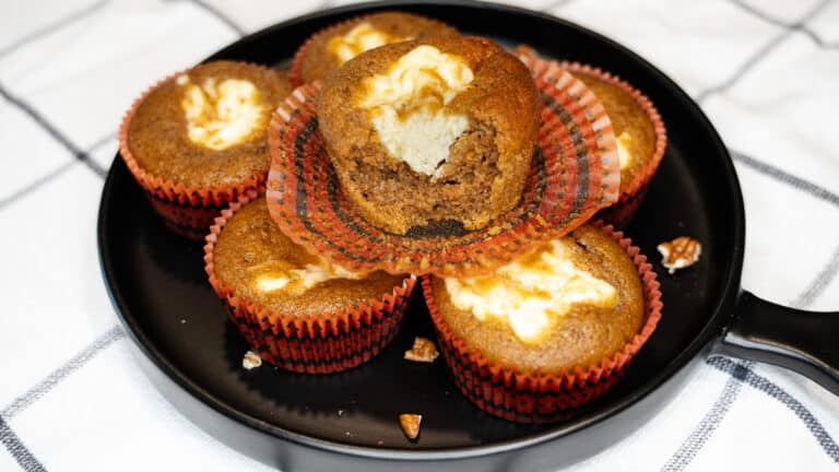 Pumpkin Cream Cheese Swirl Muffins sitting on a plate