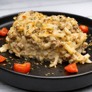 breakfast casserole sitting on a black circle plate